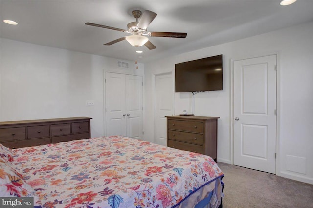 bedroom featuring ceiling fan and light colored carpet