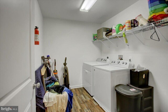 washroom featuring separate washer and dryer and hardwood / wood-style flooring