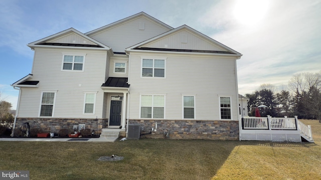 craftsman-style house with a front lawn, central air condition unit, and a deck