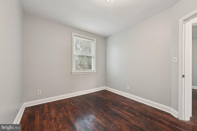 empty room with dark wood-type flooring