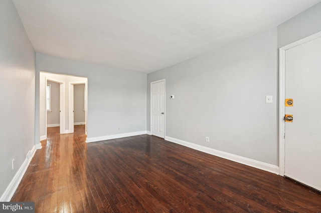 spare room featuring dark wood-type flooring