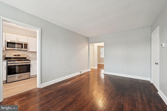 unfurnished living room featuring dark hardwood / wood-style floors