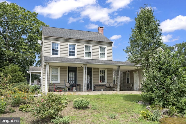 view of front of property featuring covered porch and a front yard