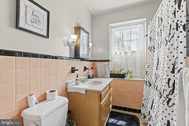 bathroom featuring a shower with curtain, vanity, toilet, and tile walls