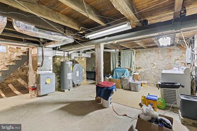 basement with washing machine and clothes dryer and water heater