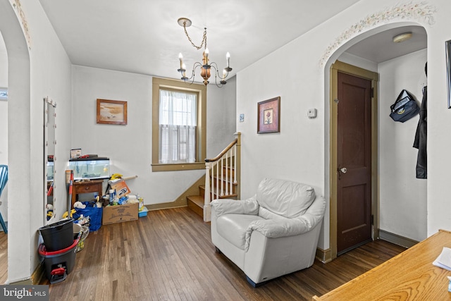 sitting room with a chandelier and dark hardwood / wood-style flooring