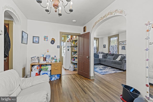 living room featuring hardwood / wood-style flooring and an inviting chandelier