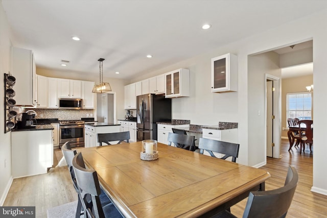 dining room featuring an inviting chandelier and light hardwood / wood-style floors