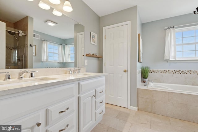 bathroom featuring vanity and independent shower and bath