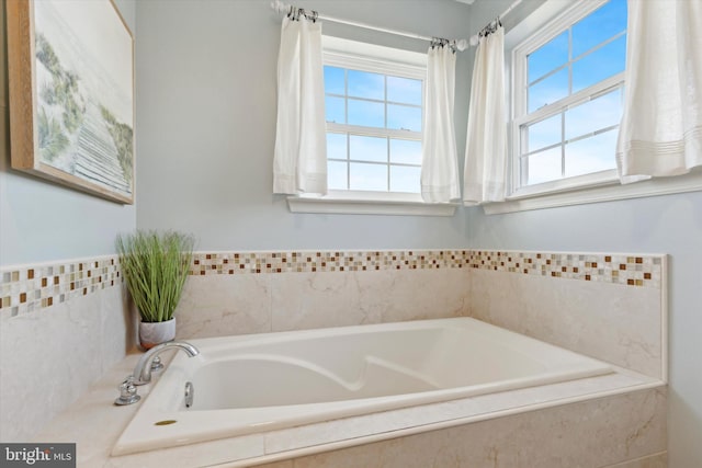 bathroom with tiled tub