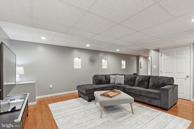 living room with a drop ceiling and hardwood / wood-style flooring