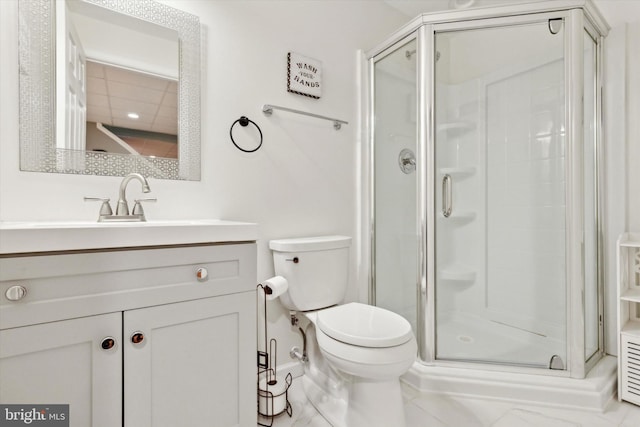 bathroom featuring an enclosed shower, vanity, and toilet