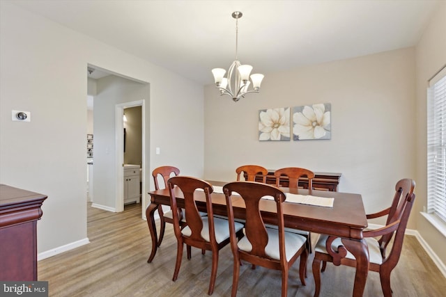 dining room with an inviting chandelier and light wood-type flooring