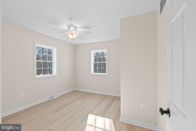 spare room with ceiling fan and light wood-type flooring