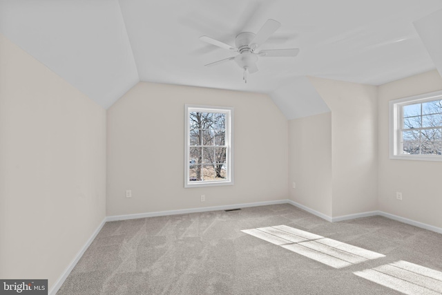 additional living space with lofted ceiling, light colored carpet, and ceiling fan