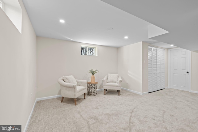 sitting room featuring light carpet