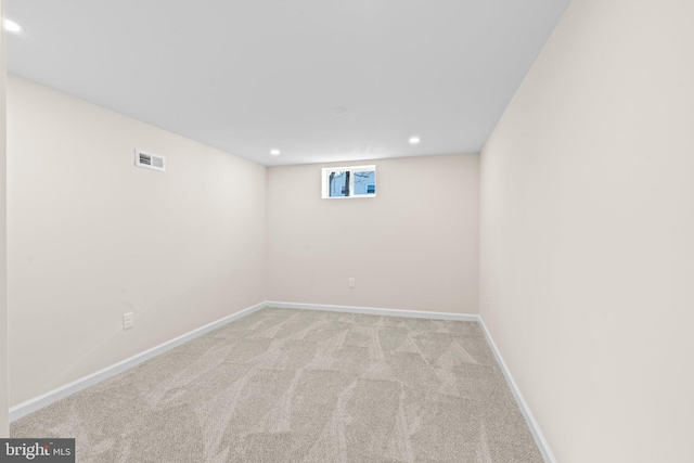 basement featuring light colored carpet