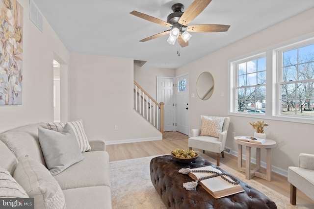 living room with ceiling fan and light wood-type flooring