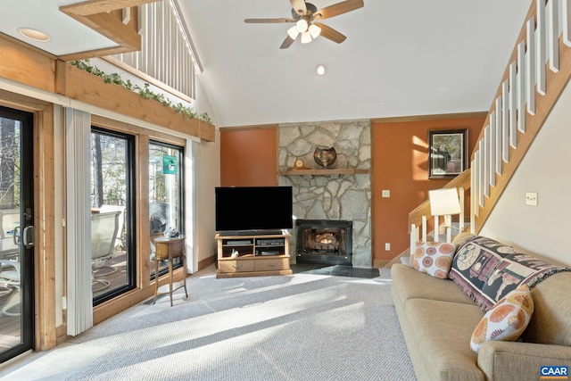 living room with a fireplace, high vaulted ceiling, ceiling fan, and carpet flooring