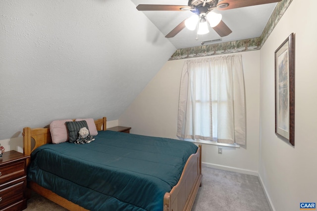 bedroom featuring lofted ceiling, light colored carpet, and ceiling fan