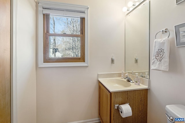 bathroom featuring vanity and toilet