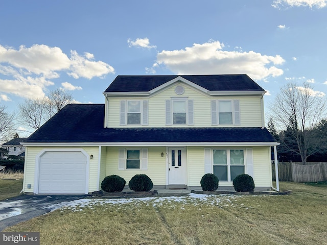 view of property with a garage and a front yard