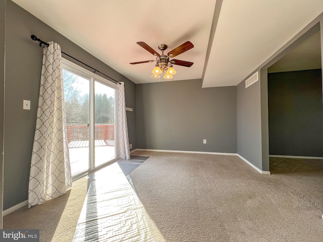 carpeted spare room with ceiling fan