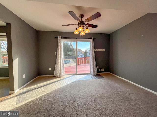 unfurnished room with ceiling fan and carpet