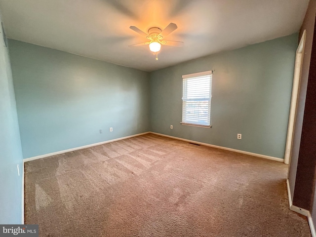 carpeted empty room with ceiling fan