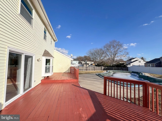 wooden deck featuring a covered pool and a patio area