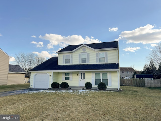 view of front property featuring a garage and a front yard