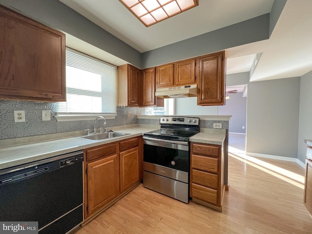 kitchen with black dishwasher, sink, decorative backsplash, stainless steel range with electric stovetop, and light hardwood / wood-style flooring