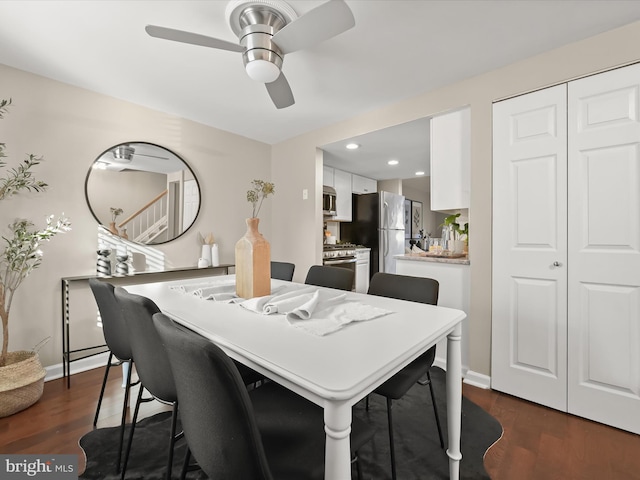 dining room with ceiling fan and dark hardwood / wood-style flooring