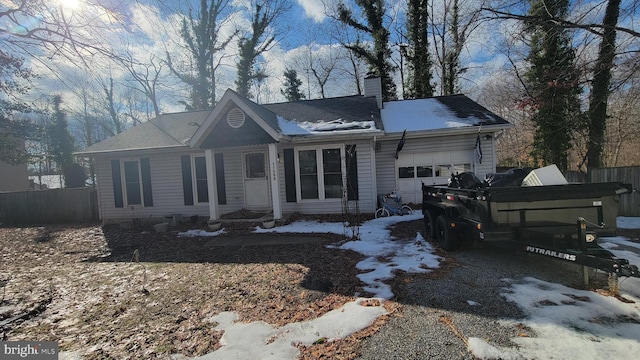 snow covered property featuring a garage