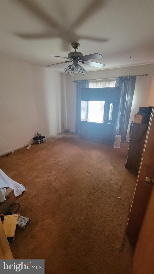 spare room with carpet floors and ceiling fan