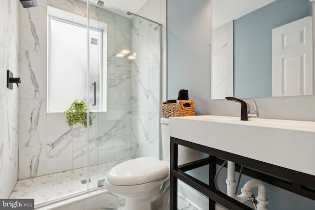 bathroom featuring vanity, toilet, and a shower with door