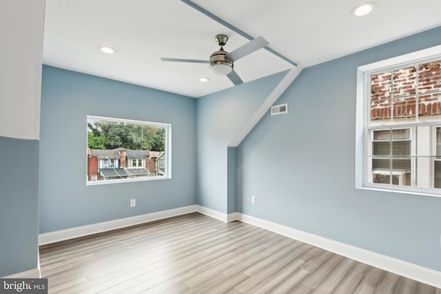 additional living space with ceiling fan and light hardwood / wood-style floors