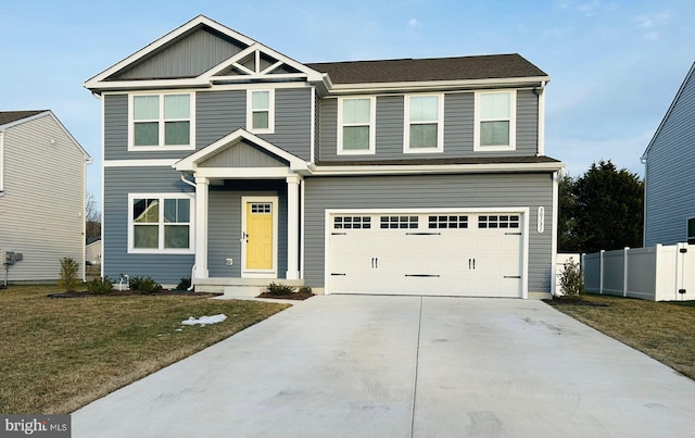 craftsman house featuring a garage and a front lawn