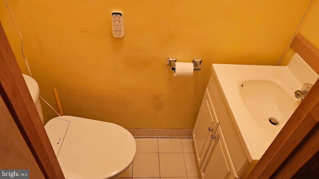 bathroom with tile patterned flooring, vanity, and toilet