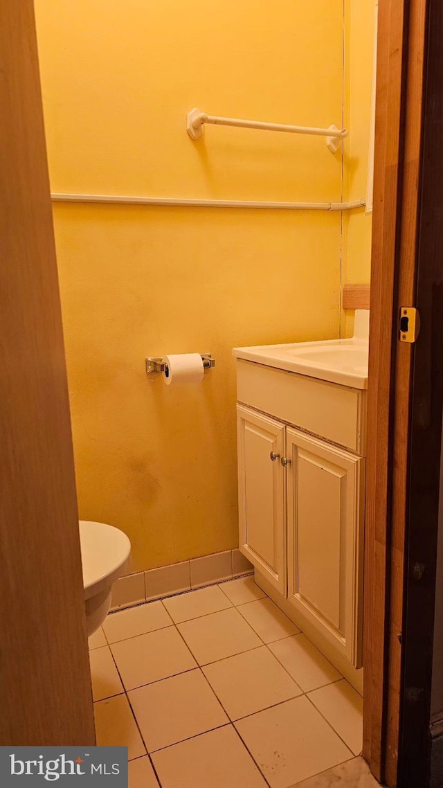 bathroom featuring tile patterned floors, toilet, and vanity