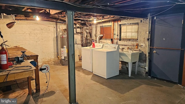 basement featuring washer and clothes dryer and gas water heater