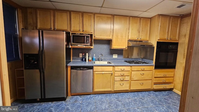 kitchen with appliances with stainless steel finishes, a paneled ceiling, sink, decorative backsplash, and light brown cabinets