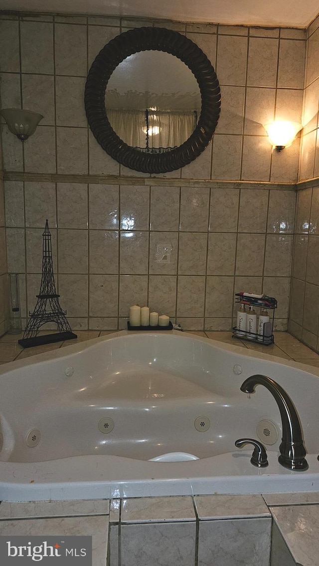 bathroom featuring tile walls and a relaxing tiled tub