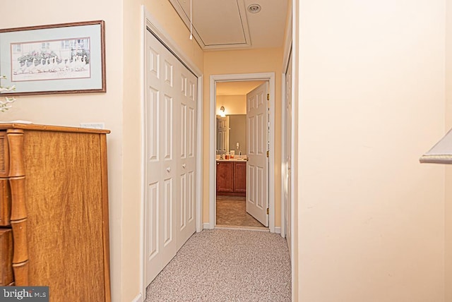 corridor featuring light colored carpet