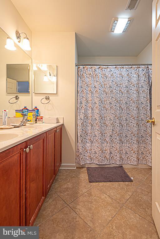 bathroom featuring vanity and tile patterned flooring