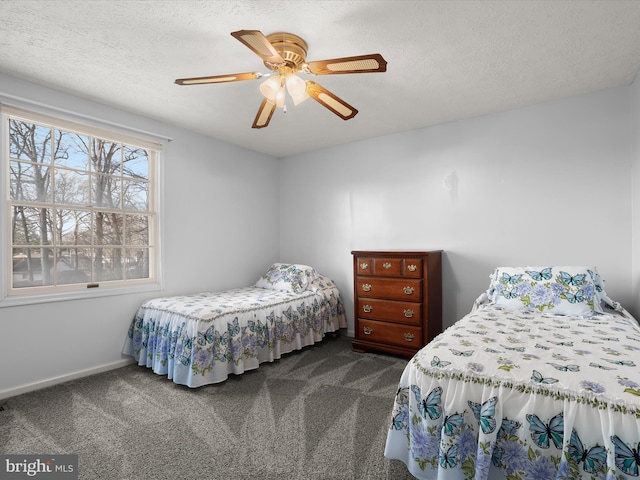 bedroom with carpet, ceiling fan, a textured ceiling, and baseboards