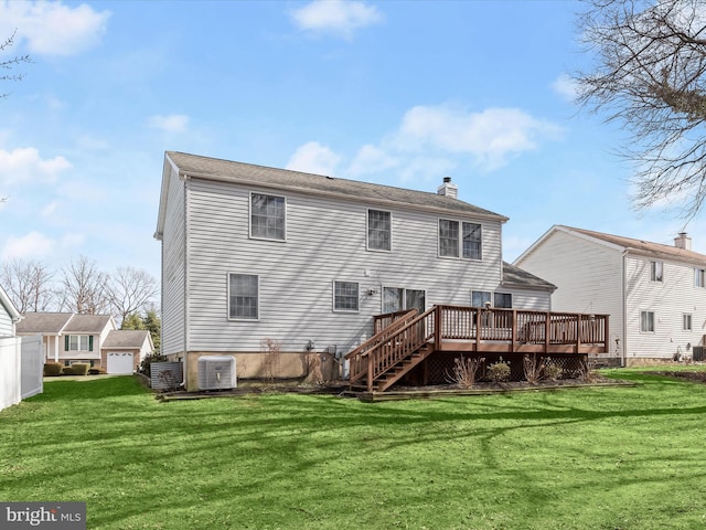 back of property with a deck, central AC, and a lawn