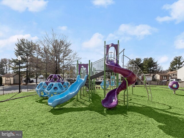 communal playground featuring a lawn