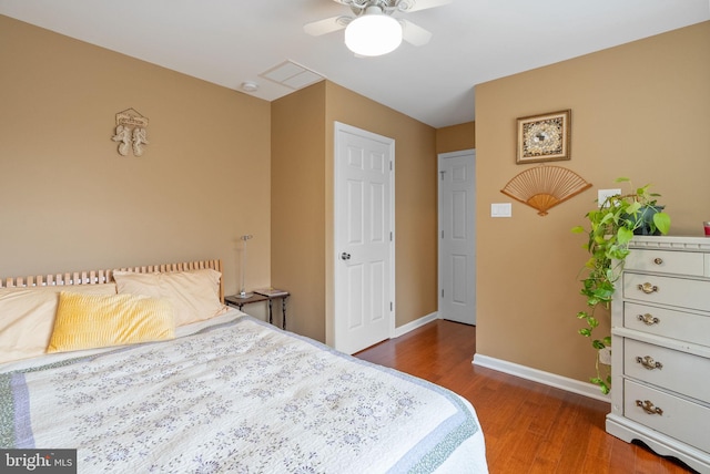 bedroom with dark wood-type flooring and ceiling fan