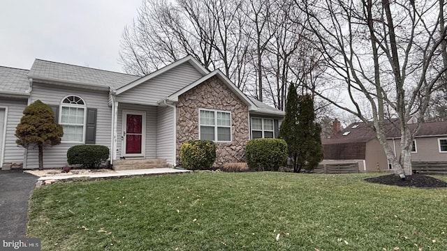 view of front of house with a garage and a front lawn